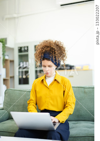 Beautiful caucasian woman working with laptop and papers 133022207