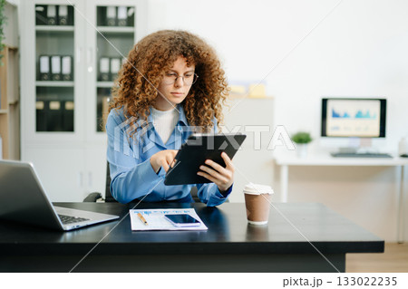 business woman working on Financial and Marketing Projects.in creative office. business woman working on Financial and Marketing Projects.in creative office. 133022235