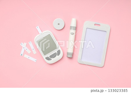 Diabetes testing equipment set on a pastel backdrop 133023385