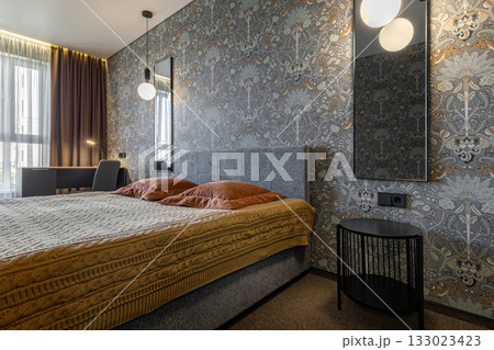 Cozy Modern Bedroom with Gray Headboard and Soft Lighting 133023423