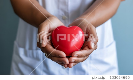 Hands holding a red heart symbolizing care and health Hands holding a red heart symbolizing care and health 133024690