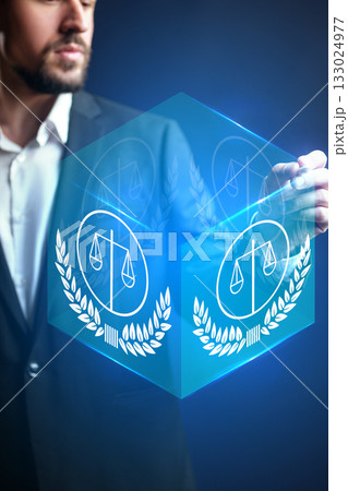 Professional man presenting a digital representation of justice and law concept Professional man presenting a digital representation of justice and law concept 133024977