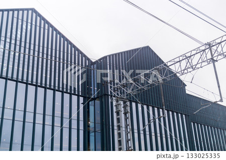 Perspective view of the facade of a modern industrial building. 133025335