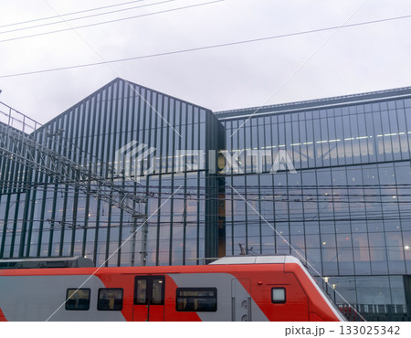 Modern high-speed train on the background of the modern office building 133025342