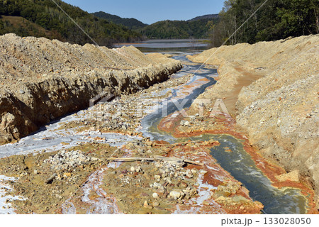 Toxic mine water discharge, acid mine drainage contaminates the environment 133028050