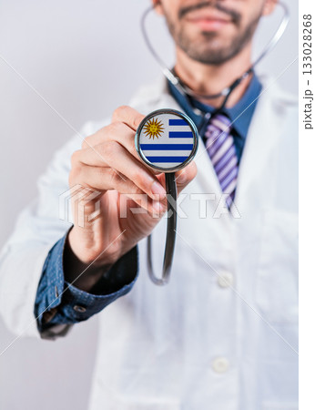 Uruguay health and medical insurance concept. Uruguay healthcare system, doctor holding stethoscope Uruguay health and medical insurance concept. Uruguay healthcare system, doctor holding stethoscope 133028268