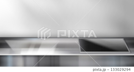 Stainless steel kitchen counter with stove top 133029294