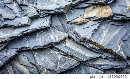 The surface contrasts with the rough pattern of the old black stone wall.The surface contrasts with the rough pattern of the old black stone wall. 133030436