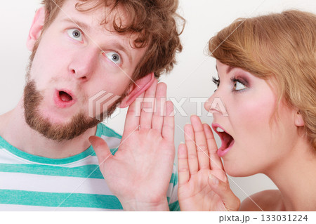 Woman telling an astonished man some secrets Woman telling an astonished man some secrets 133031224