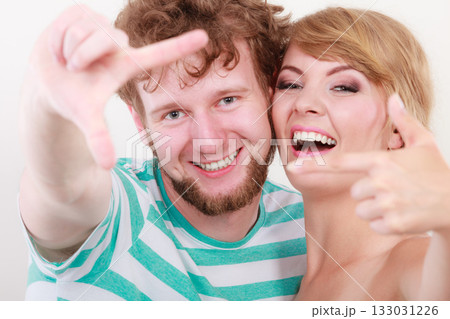 happy couple making frame with hands happy couple making frame with hands 133031226
