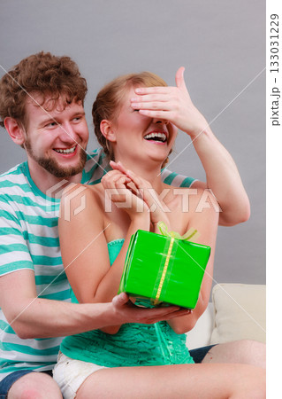 Young man giving woman gift box 133031229