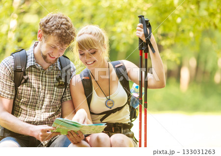Hikers backpackers couple reading map on trip. Hikers backpackers couple reading map on trip. 133031263