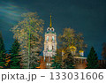 The majestic bell tower of the Assumption Cathedral behind the Tula Kremlin wall, brightly illuminated at night. A fairytale view of Russian Orthodox architecture in Tula, Russia. 133031606