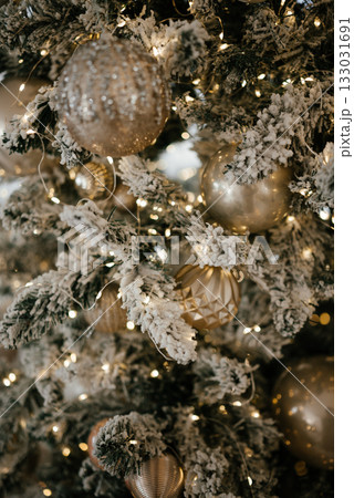 Elegant Christmas Tree with Ornaments and Snowy Branches 133031691