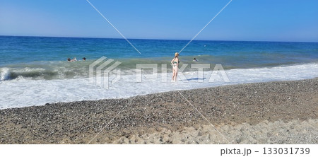 back light shinny portrait of young happy Asian woman relaxed looking at wild sea waves on sunset beach in Kreta Greece enjoying sun and sea breeze in relax holiday and summer vacation trip back light shinny portrait of young happy Asian woman relaxed looking at wild sea waves on sunset beach in Kreta Greece enjoying sun and sea breeze in relax holiday and summer vacation trip 133031739