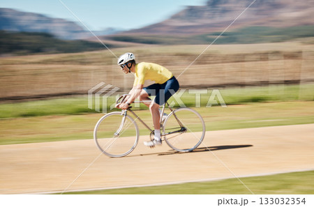 Man cycling with blurred background speed in nature, countryside and training for triathlon, sports and power. Cyclist, bicycle and motion of bike for fitness, energy and exercise performance on path 133032354
