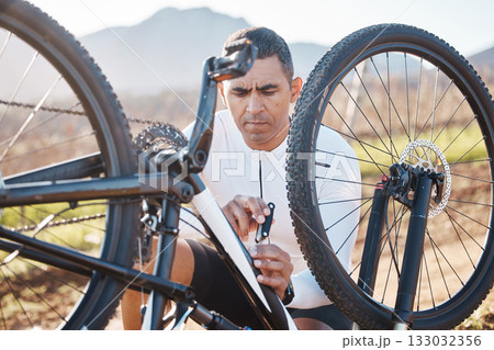 Repair, tools and check with man and mountain bike for fitness, training or exercise in nature. Cycling, sports and adventure with cyclist fixing bicycle on trail for gears, maintenance or inspection 133032356