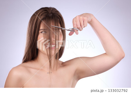 Beauty, grooming and woman cutting her hair in studio on a gray background for style or care. Salon, shampoo and haircut with an attractive young female trimming her hairstyle for haircare 133032792