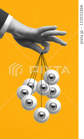 Bright poster. Hand holding multiple eyes on strings on yellow background 133032866