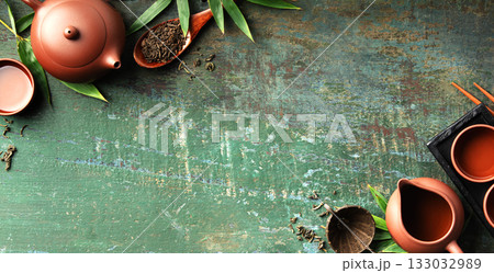 Assorted Loose Leaf Teas with Clay Teapot and Teacups on Rustic Surface Assorted Loose Leaf Teas with Clay Teapot and Teacups on Rustic Surface 133032989