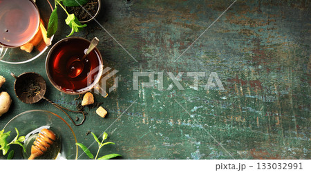 Herbal Tea with Lemon, Ginger, Mint, and Honey on Rustic Background 133032991