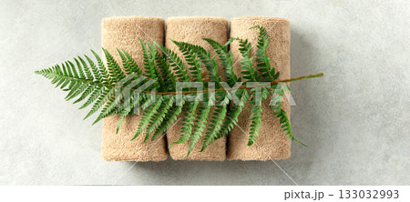 Spa Towels with Green Fern on Light Minimal Background Spa Towels with Green Fern on Light Minimal Background 133032993