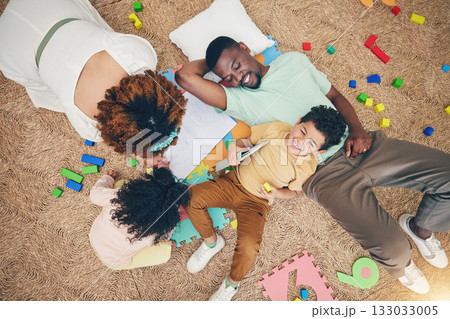 Top view, family and parents with children on floor with toys, number puzzle and bonding at home. Happy, educational games and mom, dad and kids smile for fun activity, creative learning and relax Top view, family and parents with children on floor with toys, number puzzle and bonding at home. Happy, educational games and mom, dad and kids smile for fun activity, creative learning and relax 133033005