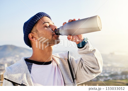 Man drinking water, runner in city with fitness and health, thirsty and hygiene with satisfaction and break from running outdoor. Bottle, h2o and eyes closed with young male, urban and exercise 133033052