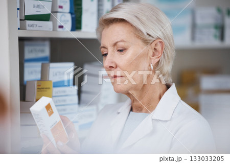 Elderly pharmacist, medicine reading and stock in a healthcare, wellness and pharmaceutical store. Pharmacy inventory, working senior woman and medical product check of a employee at a drugstore 133033205