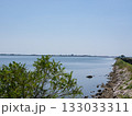 Grado, Italy - July 30th 2024: Dam towards the touristic village of Grado behind the lagoons and islands 133033311