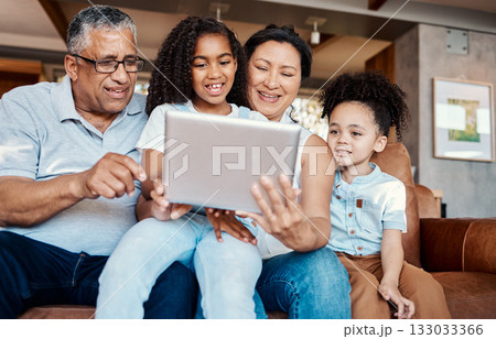Family, relax and girl with tablet on sofa in home living room for social media or funny video streaming. Technology, care and happy grandfather, grandma and kids laughing or bonding with touchscreen Family, relax and girl with tablet on sofa in home living room for social media or funny video streaming. Technology, care and happy grandfather, grandma and kids laughing or bonding with touchscreen 133033366