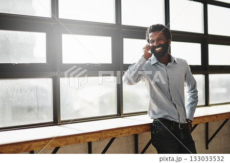 Window, phone call or idea and a business man in the office with a smile while planning or networking. Happy, vision and mobile contact with a male employee standing in the workplace during his break 133033532