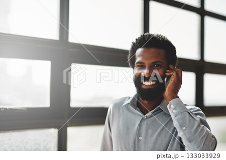 Portrait, window and phone call with a business man in the office for communication or networking. Face, happy and contact with a happy male employee networking in the workplace during his break 133033929