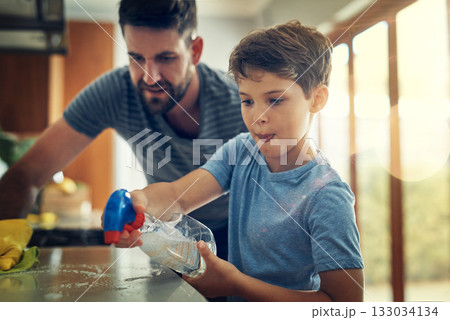 Family, father and son cleaning the kitchen counter, development and growth at home. Parent, male child and dad with kid, support and teaching with chores, helping and learning with responsibility 133034134