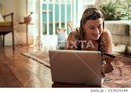 Computer, credit card and woman with home online shopping, e commerce and fintech, loan or payment on floor. Happy person relax and typing her banking information on laptop for website ecommerce Computer, credit card and woman with home online shopping, e commerce and fintech, loan or payment on floor. Happy person relax and typing her banking information on laptop for website ecommerce 133034144