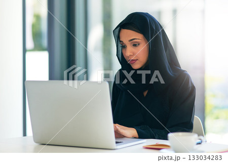 Woman, muslim and laptop for career is working at the office on the internet for dubai and technology. Professional, computer and arabic with a hijab is on the web to design at a company with tech. Woman, muslim and laptop for career is working at the office on the internet for dubai and technology. Professional, computer and arabic with a hijab is on the web to design at a company with tech. 133034283