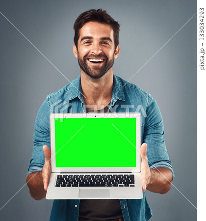 Happy man, laptop and portrait with mockup green screen for advertising or marketing against grey studio background. Male person showing computer display, chromakey or mock up space for advertisement 133034293