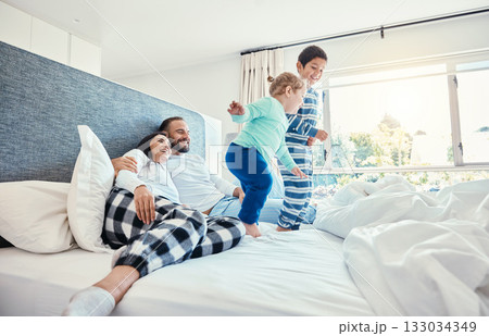 Family, morning and kids jumping on a bed, playing while having fun in the bedroom of their parents. Happy, children or wake up with a brother and sister in a house feeling playful or excited Family, morning and kids jumping on a bed, playing while having fun in the bedroom of their parents. Happy, children or wake up with a brother and sister in a house feeling playful or excited 133034349