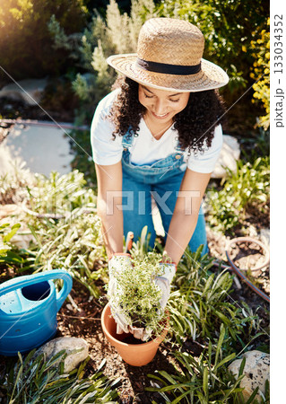 Spring, plants and smile, woman gardening in sun for eco friendly hobby and sustainable weekend time. Flowers, agriculture and growth, happy gardener planting bush in pot in backyard garden in Brazil Spring, plants and smile, woman gardening in sun for eco friendly hobby and sustainable weekend time. Flowers, agriculture and growth, happy gardener planting bush in pot in backyard garden in Brazil 133034352