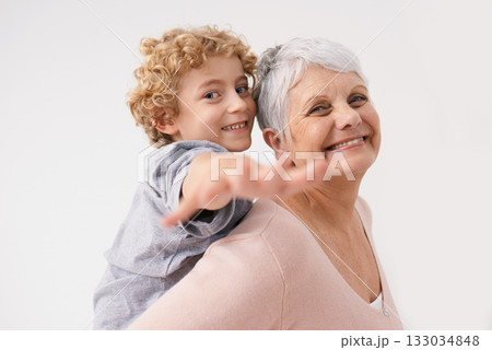 Portrait, piggyback or happy grandma with a playful child or smile hugging or smiling with love as a family together. Hand, boy or fun elderly grandmother relaxing, bonding or playing in retirement 133034848
