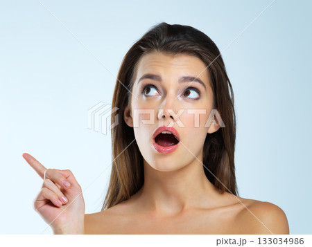 Wow, pointing and beauty woman isolated on blue background for sale, discount or makeup promotion deal. Surprise face of cosmetics model or young person in studio showing mockup or product placement Wow, pointing and beauty woman isolated on blue background for sale, discount or makeup promotion deal. Surprise face of cosmetics model or young person in studio showing mockup or product placement 133034986