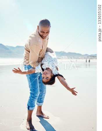 Family, beach and father carry girl playing by ocean for bonding, quality time and relaxing on weekend. Love, nature and happy dad holding child on summer holiday, vacation and adventure together 133035102