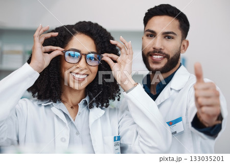Pharmacy workers, portrait and thumbs up of pharmacist, healthcare and wellness staff with glasses. Thank you, teamwork and motivation hand sign of medical workers in a clinic or hospital with smile Pharmacy workers, portrait and thumbs up of pharmacist, healthcare and wellness staff with glasses. Thank you, teamwork and motivation hand sign of medical workers in a clinic or hospital with smile 133035201