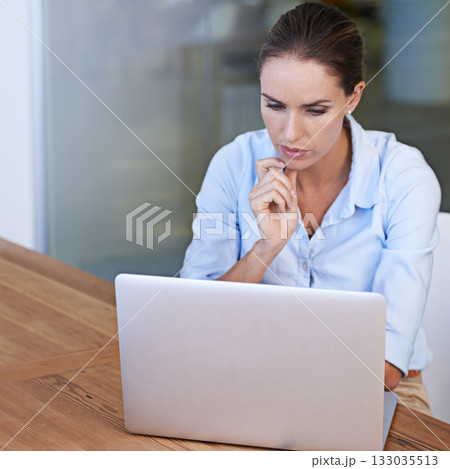 Business woman, thinking and serious at laptop to research ideas, brainstorming solution and online planning. Focused female worker at computer for decision, analysis or reading information at mockup 133035513