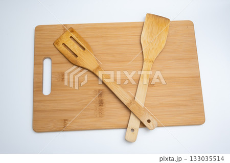 Bamboo Cutting Board with Spatulas on White Background Bamboo Cutting Board with Spatulas on White Background 133035514