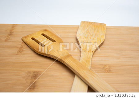 Bamboo Cutting Board with Spatulas on White Background 133035515