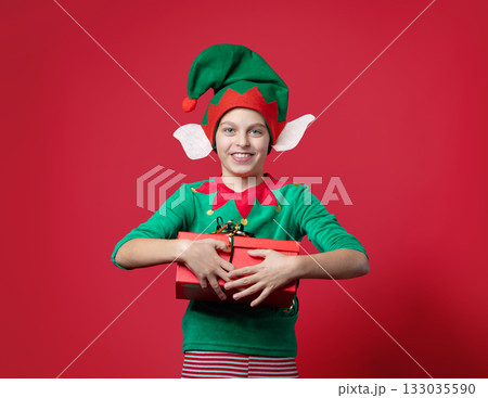 Happy surprise, impression, emotions boy dressed as a Christmas elf holding 133035590