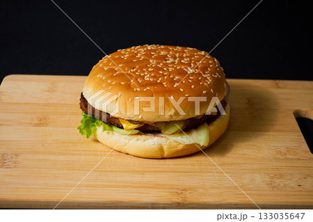 Juicy Hamburger with Lettuce and Onion on Board Juicy Hamburger with Lettuce and Onion on Board 133035647