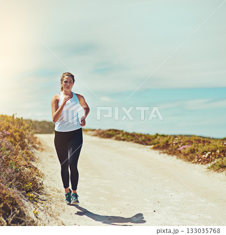 Woman running on road, fitness outdoor with cardio and training for race with athlete, sports and mockup space. Female runner in nature, blue sky and run for exercise with healthy and active person Woman running on road, fitness outdoor with cardio and training for race with athlete, sports and mockup space. Female runner in nature, blue sky and run for exercise with healthy and active person 133035768