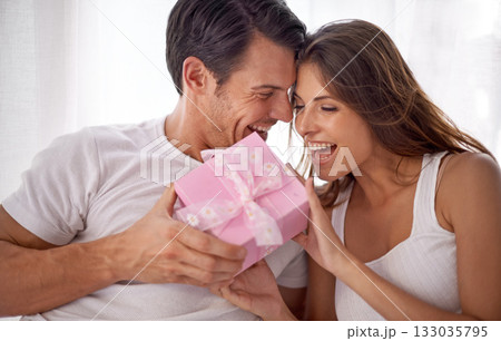 Man giving woman gift, love and happiness with partnership, relationship and celebration on Valentines day date. Couple laugh with present, luxury and commitment, gratitude and celebrate holiday 133035795